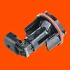A black automotive part with a red seal against an orange background. Produktbild-Vorschau