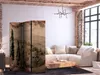 A living room with a sectional sofa, coffee table, and a decorative room divider. Produktbild-Vorschau