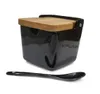 A black ceramic sugar bowl with a wooden lid and a black spoon, displayed on a white background. Anteprima dell’immagine prodotto