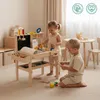 Two children playing with a wooden toy workbench in a room. Náhled obrázku produktu