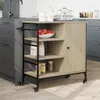A kitchen cart with shelves and a cabinet is shown in a kitchen setting. Náhled obrázku produktu