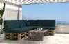 A dark green pallet sofa set with a wooden coffee table on a balcony overlooking the sea. Produktbild-Vorschau