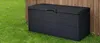 A black outdoor storage box is placed on a green lawn next to a wooden fence. Podgląd zdjęcia produktu