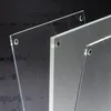 Three clear acrylic sheets with drilled holes are displayed diagonally against a dark background. Náhľad obrázku produktu