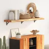 A wooden shelf with decorative items is mounted on a white wall above a wooden cabinet. Voir les images du produit