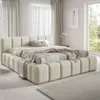 A modern upholstered bed in a bedroom setting.