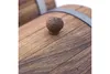 A close-up shot of a wooden barrel with a metal band and a wooden knob. Podgląd zdjęcia produktu