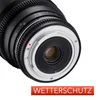 A close-up view of the rear mount of a camera lens, showing the metallic bayonet mount and some distance markings. Produktbild-Vorschau