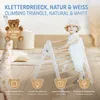 A child is playing on a climbing triangle indoors. Produktbild-Vorschau