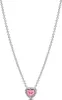 A close-up studio shot of a silver necklace with a pink heart-shaped pendant. Podgląd zdjęcia produktu
