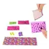 A collection of colorful craft supplies, including patterned paper strips, small accessories, and a person's hands holding a piece of paper. Anteprima dell’immagine prodotto