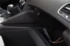 Interior of a car, showing a storage compartment with a GPS tracker inside. Náhled obrázku produktu