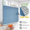 A blue pleated blind is shown hanging in a window, with a close-up inset showing the front and back of the material. Icons and text highlight product features. Produktbild-Vorschau