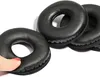 A hand is holding one of three black ear pads for headphones. Voir les images du produit