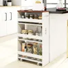 A white kitchen cart with four shelves filled with jars and bottles, placed next to a kitchen counter. Podgląd zdjęcia produktu