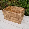 A wooden crate is placed on a light-colored wooden surface in front of a green hedge. Náhled obrázku produktu