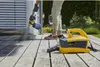 A person is using a paint spray system on a wooden deck outdoors. Anteprima dell’immagine prodotto