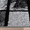 A close-up view of a rug with a geometric pattern. Produktbild-Vorschau
