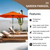 An orange garden parasol is set up over two lounge chairs on a patio. Voir les images du produit