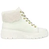 A white high-top sneaker boot with beige laces and a faux fur collar, shown from the side against a white background. Produktbild-Vorschau