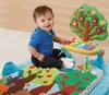 A baby is playing on a colorful musical playmat with an interactive toy. Produktbild-Vorschau