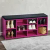 A pink shoe cabinet with a black seat cushion on top, filled with various shoes and a handbag. Produktbild-Vorschau