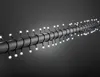 A string of white LED lights wrapped around a dark, cylindrical object against a gray background. Produktbild-Vorschau