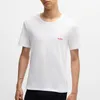 A man wearing a white t-shirt with a small red logo on the chest. Produktbild-Vorschau