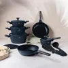A collection of dark blue cookware and kitchen utensils arranged on a light-colored surface. Anteprima dell’immagine prodotto