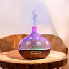 An aroma diffuser with LED lights sits on a wooden table. Produktbild-Vorschau