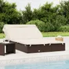 A double sun lounger with a canopy is placed on a patio next to a swimming pool, with lush green trees and bushes in the background. Náhľad obrázku produktu
