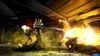 Two soldiers in combat gear are firing weapons at an alien creature in a dimly lit, industrial-looking environment. There is a large explosion and smoke. Produktbild-Vorschau