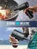 A person is holding a black air blower, demonstrating its use for blowing on a fire and inflating an air mattress. Podgląd zdjęcia produktu