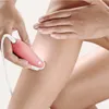A person is using a pink and white epilator on their leg. Náhľad obrázku produktu