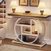 A console table with shelves is placed in a hallway next to a staircase. The table is decorated with lamps, books, and decorative items. Anteprima dell’immagine prodotto