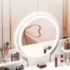 A vanity table with a lighted mirror and makeup accessories. Podgląd zdjęcia produktu