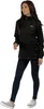 A woman is standing and posing in a black jacket and dark pants. Produktbild-Vorschau