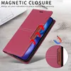 A red leather flip wallet phone case is shown on a wooden surface, with a laptop in the background. Red arrows indicate the magnetic closure feature. Produktbild-Vorschau