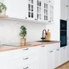 A modern kitchen with white cabinets, a wooden countertop, and a speckled backsplash. Náhľad obrázku produktu