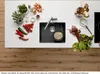 A top-down view of a kitchen counter with a sink, vegetables, herbs, and utensils. Produktbild-Vorschau