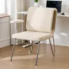 A beige upholstered chair with silver metal legs is shown in a home office setting, next to a desk with a laptop. Anteprima dell’immagine prodotto