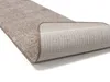 A close-up view of a rolled-up rug, showing both the textured top and the non-slip backing. Produktbild-Vorschau