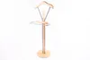 A valet stand with a wooden base and frame, and metal accents. Anteprima dell’immagine prodotto