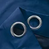 A close-up view of two grommets on a blue curtain. Anteprima dell’immagine prodotto