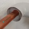 A close-up view of a copper pipe being inserted into a white insulation sleeve. Produktbild-Vorschau