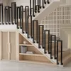 A modern staircase with black metal railings and built-in wooden shelving and cabinets. Náhľad obrázku produktu