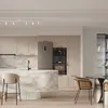 A modern kitchen with a marble island, bar stools, and a dining area. Podgląd zdjęcia produktu