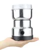 A hand is holding a small electric coffee grinder. Produktbild-Vorschau