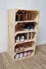 A wooden shoe rack made of crates, filled with various shoes. Produktbild-Vorschau