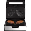 An open fish-shaped waffle maker with two cooked fish-shaped waffles inside. Podgląd zdjęcia produktu